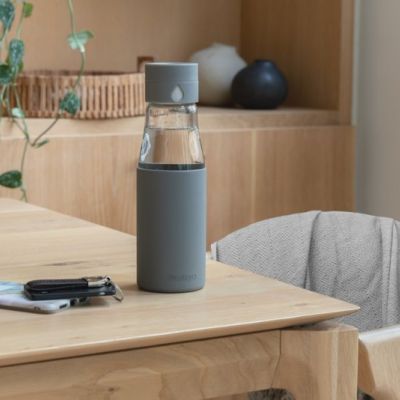 Ukiyo glass hydration tracking bottle with sleeve